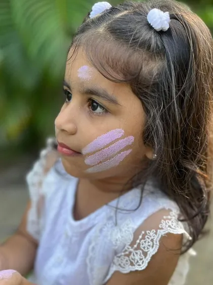 A close-up of the beautiful, gentle purple colour on her cheek. Unlike chemical colours, my clay-based powders don't stain or cause rashes.
