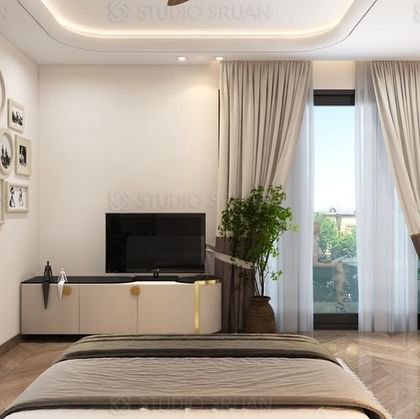 This view showcases the opposite wall of the bedroom, with a clean, minimalist TV console and a gallery wall of personal photos, adding a personalized touch to the modern design.