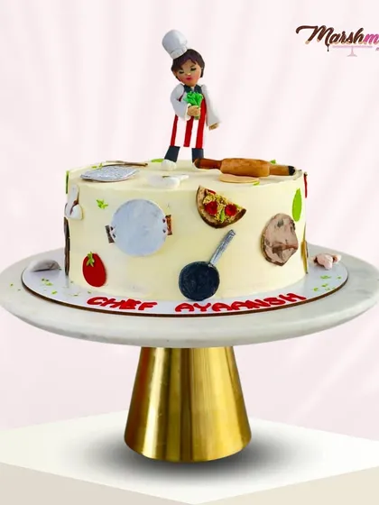 A side view of the chef-themed cake, showing the different edible tools placed around the cake. It’s a celebration of a young boy's passion.