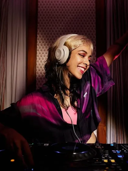 Hands up, feeling the music. This professional shot captures the 'lovergirl energy' I bring to every set.