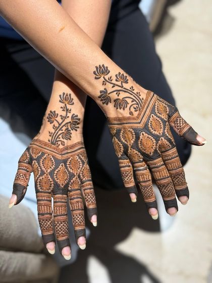 A modern and bold design with a floral vine on the back of the hand.