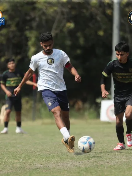 A player dribbling forward, looking to break the lines. This photo captures the focus and control required to compete at the highest level.