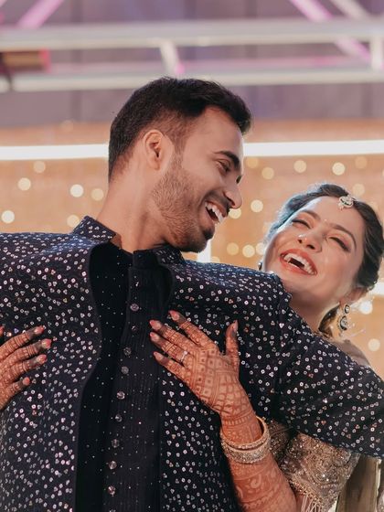 Pure, uninhibited laughter between the couple during a dance at their engagement party, a perfect candid moment.