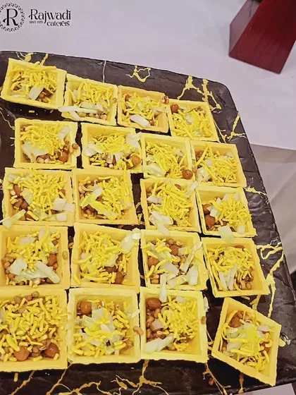 I offer a variety of creative chaat options that are perfect for any party. These are individual tokri chaat canapés, neatly arranged and ready to be served as a delicious, bite-sized appetizer for your guests to enjoy.