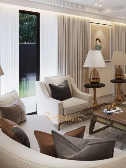 A living space crafted for serenity, with a calm color palette of beige and grey, accented by warm lighting from sculptural table lamps.