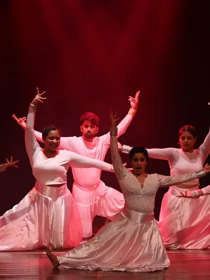 A graceful pose from the Indian contemporary piece at 'Manch 24.' The dancers in their white costumes create a serene and elegant picture on stage.