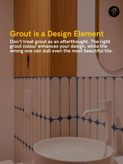Grout is a critical design element, not an afterthought. The right grout color can enhance your tile design, like this blue grout that creates a stunning graphic pattern with white vertical tiles.