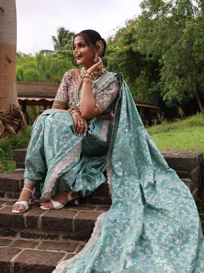 For a modern and elegant look, this pastel blue ready-to-wear Nauvari is a perfect choice. The light fabric and subtle floral pattern make it comfortable for any day-long function or a pre-wedding shoot.