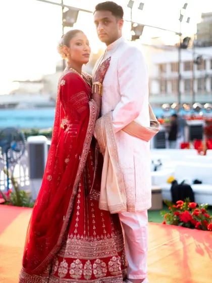 A stylish, editorial-style portrait of the couple. The bride's direct gaze at the camera adds a confident and modern touch.