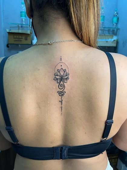 A full view of the unalome lotus back tattoo. The placement along the spine is very popular for this design.