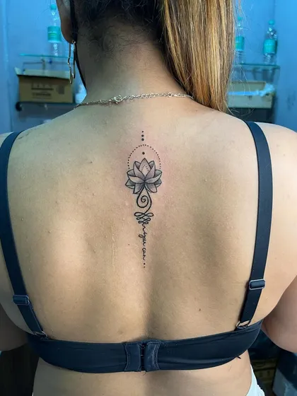 A full view of the unalome lotus back tattoo. The placement along the spine is very popular for this design.