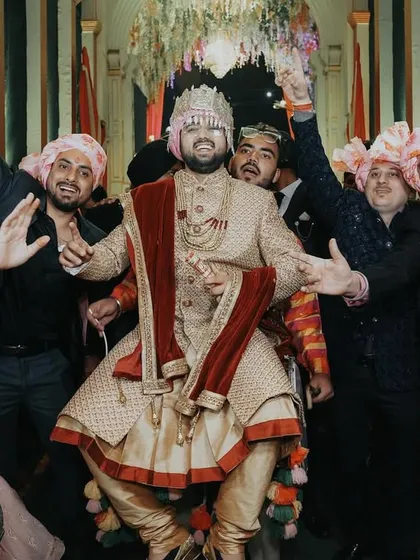 The groom's entry should be full of energy! This shot captures the groom enjoying his baraat, dancing with his friends and family. It's these high-energy, fun-filled candid moments that make a wedding album complete.