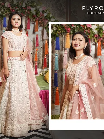 Elevate your style with this exquisite pastel pink lehenga. The delicate embroidery and soft color make it a perfect choice for a day wedding or a sangeet night.