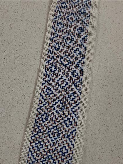 A single Kasuti bookmark showcasing a classic geometric design. The precision of the stitches is a testament to the meditative focus that this craft encourages.