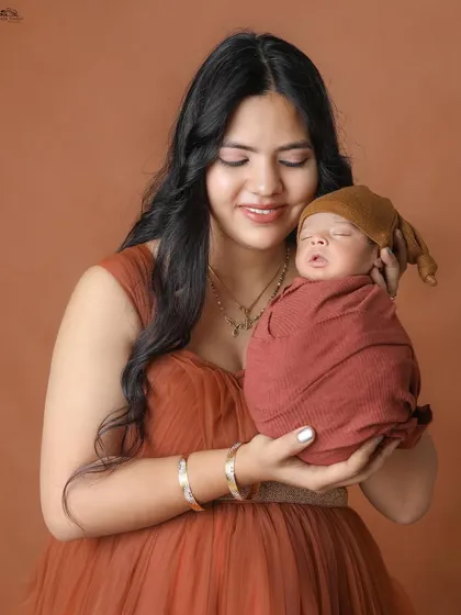 A new mother admiring her sleeping baby. The warmth and love in this photo are palpable.
