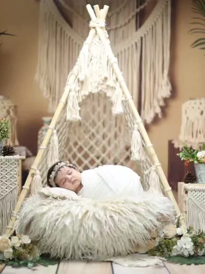 A wide view of our popular boho teepee setup, showcasing the intricate macrame details, lush plants, and soft textures that define this beautiful style.