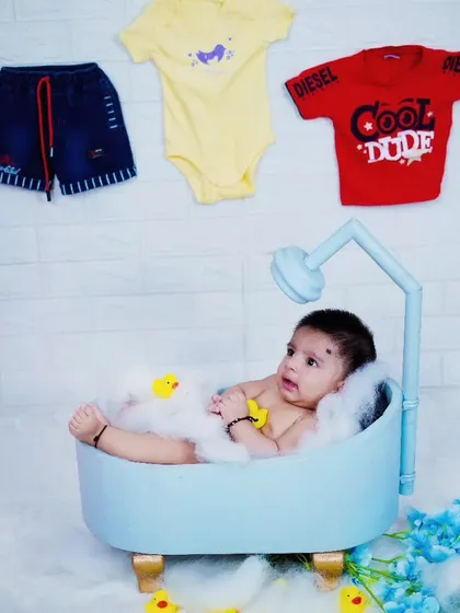 Our bathtub theme is a fun and unique way to capture baby photos. This little one is enjoying a bubbly bath with rubber ducks.
