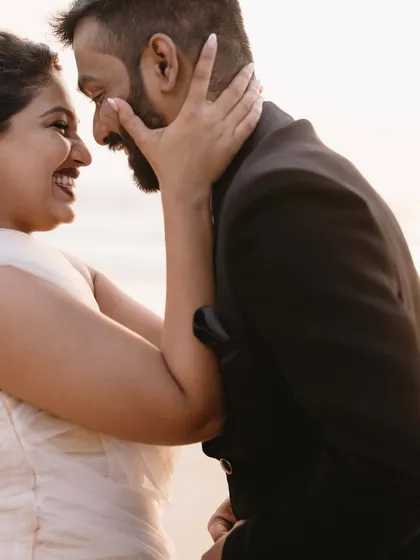 A close up of pure happiness. The way they look at each other, with the soft light of the sunset on their faces, tells a story of deep affection and excitement for their future.