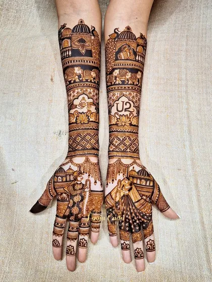 The same U2-themed bridal design, showcasing the beautiful bride and groom figures on the palms, proving that personal passions can be part of your traditional mehendi.
