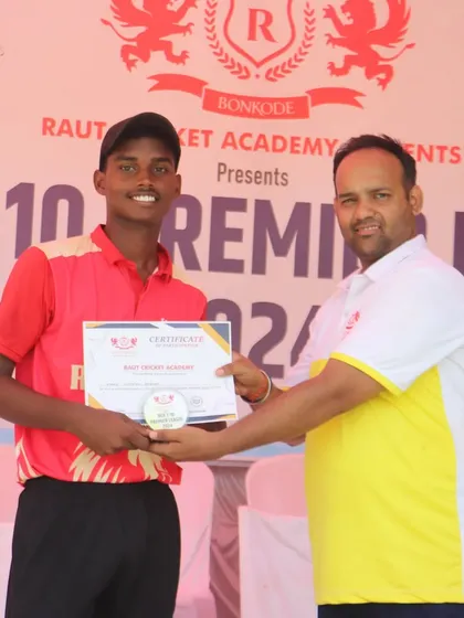 A player from the champion team, RCA Kings, receives his certificate.