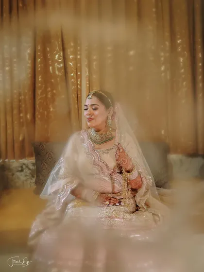 An artistic and serene bridal portrait captured in a quiet moment before the ceremony. We aim to create timeless, elegant portraits that reflect the bride's personality and the beauty of her wedding attire.