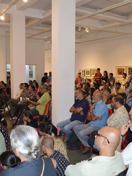 A wide view of the packed audience at the artist talk.