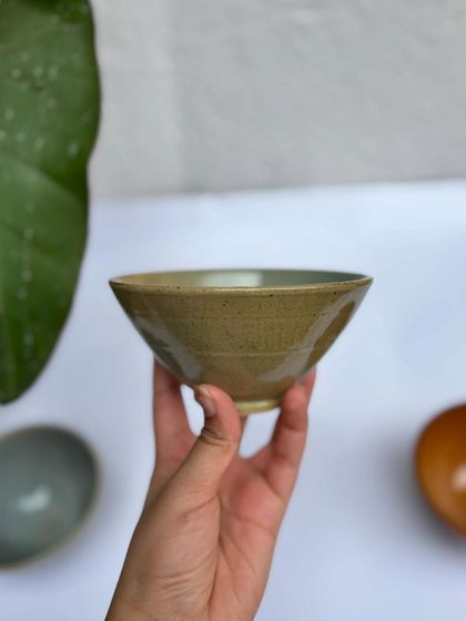 A fruit bowl in our Green Celadon glaze. The earthy green is versatile and timeless.