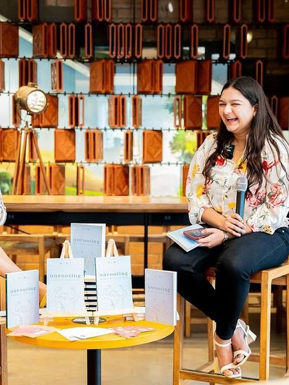 Two authors sharing the stage during the "Unrooting" book tour, creating a dynamic and engaging interview format.