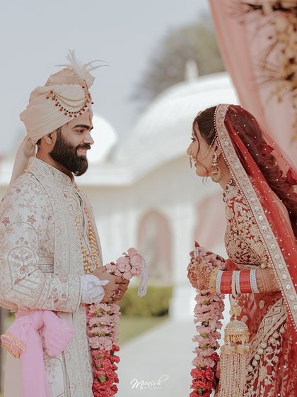 The Varmala exchange, filled with smiles and playful energy, a classic and joyful moment in any Hindu wedding.