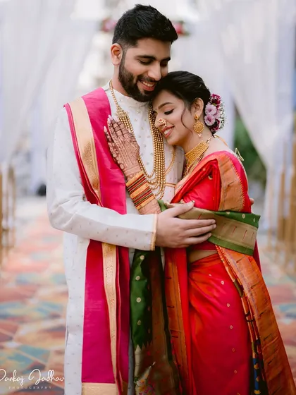 A warm embrace between Zaee and Kartik during their traditional Maharashtrian engagement ceremony. The rich colors of their outfits and the genuine emotion make this a cherished memory.
