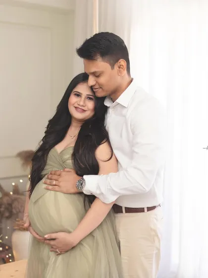 Another intimate moment between the couple, framed by the soft light of the studio. These quiet, connected portraits are a beautiful way to remember the journey to parenthood.