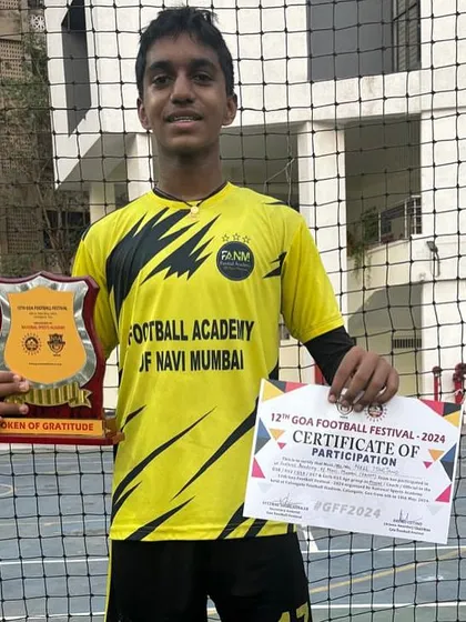 A proud moment for one of our players, holding his certificate and a token of gratitude from the tournament organizers.