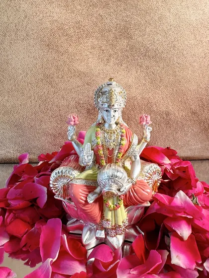 A solo view of the exquisite hand-painted Goddess Lakshmi idol, capturing her serene expression and the pot of wealth she holds.