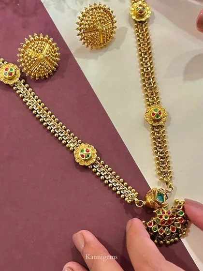 This traditional gold necklace and earring set features intricate beadwork and colorful enamel details. It is a labor of love, designed to last through the ages and be part of your family's story.