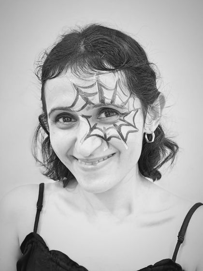 Simple but effective. A student sports a spiderweb face painting design at our Halloween studio party. It's all about having fun and getting creative.