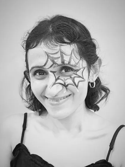 Simple but effective. A student sports a spiderweb face painting design at our Halloween studio party. It's all about having fun and getting creative.