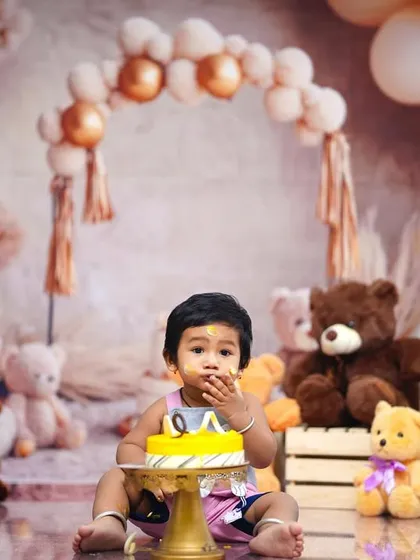 Perfect for a first birthday, our 'Teddy Bear Picnic' theme includes a cake smash moment. Here, the birthday boy enjoys his cake surrounded by his furry friends.