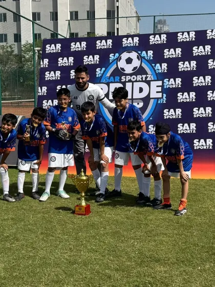 The complete Under 10 squad with their coach and the SAR Pride Cup trophy. A proud moment for everyone involved.