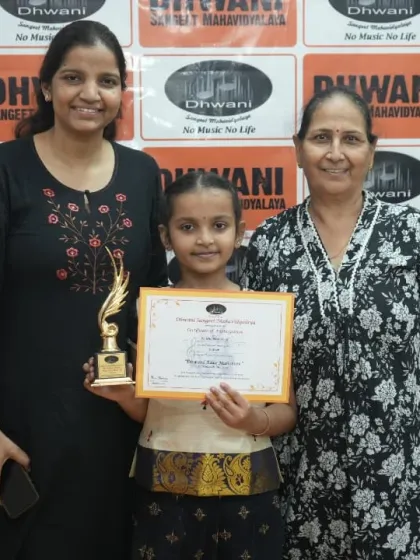 A student with her mother and grandmother, celebrating her achievement.