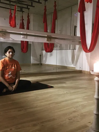 Practicing Trataka, or candle gazing meditation. This powerful yogic technique improves focus, calms the mind, and enhances concentration by fixing the gaze on a single point of light.