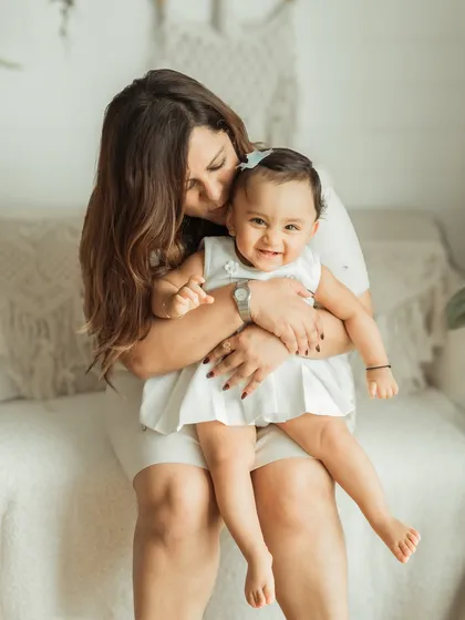 A mother's gentle kiss for her happy daughter. These are the tender moments I live to capture.