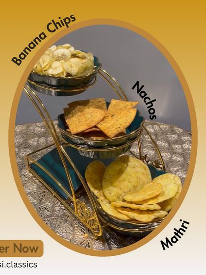 Our snack platter is perfect for sharing. It features a trio of our crunchy favourites: homemade Banana Chips, zesty Moong Dal Nachos, and traditional Mathri.