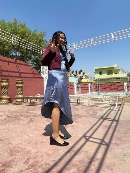 A performer strikes a pose during a pre-show rehearsal. Our poets bring their unique personalities and styles to every performance.