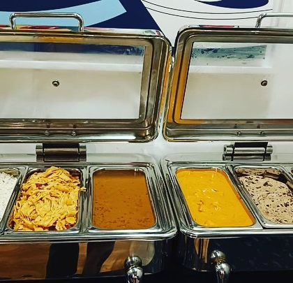 My multi-section chafing dishes allow me to serve a complete meal in one unit. Here you can see rice, a dry vegetable dish, dal, a paneer gravy, and more.