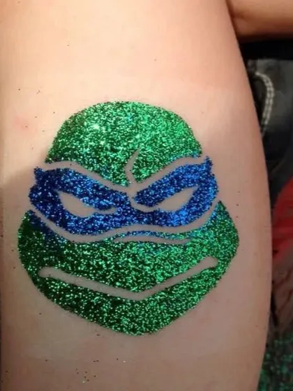 A Teenage Mutant Ninja Turtle glitter tattoo. I can create designs of all your favorite cartoon characters to perfectly match your party's theme.