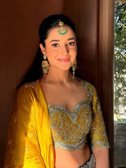 A sun-kissed shot of the haldi look, showing how the makeup glows in natural light. The finish is luminous and perfect for a day event.
