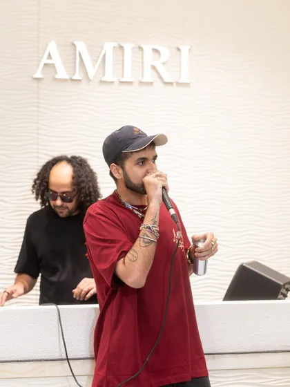 Music curation is about matching the sound to the space. Here I am on the decks with an artist during the launch of Amiri's first store in India, creating a sonic identity that complements the brand's high-end, rock-and-roll aesthetic.