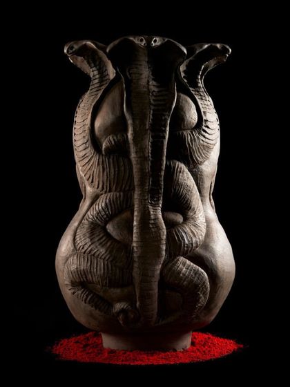 The back of the 'Cosmic Temple' sculpture, where intertwined snakes represent the rising of kundalini energy. This form took months of coiling and carving, a true labor of love and patience.