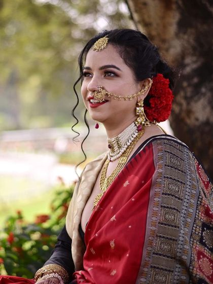 She chose a beautiful vintage look for her reception day. The winged eyeliner, bold lip, and traditional jewelry create a look that is both classic and striking.