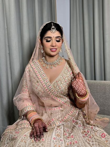 This bride was a vision in her pastel pink and ivory lehenga. I used silver and pink tones on her eyes to complement the embroidery on her outfit.